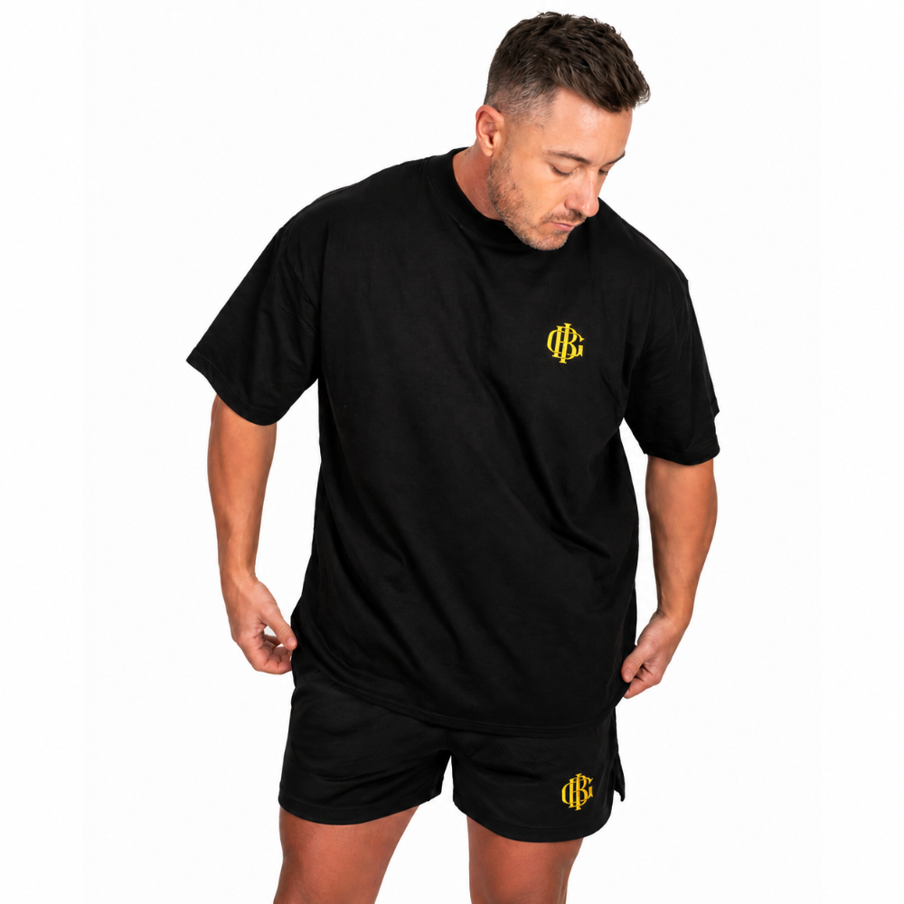 Man wearing the black BIG gym shorts, full length shot