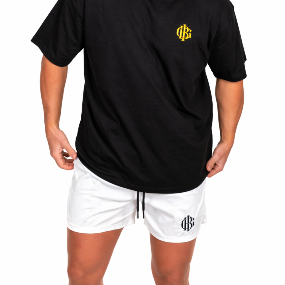 Man wearing the white BIG gym shorts, full length shot