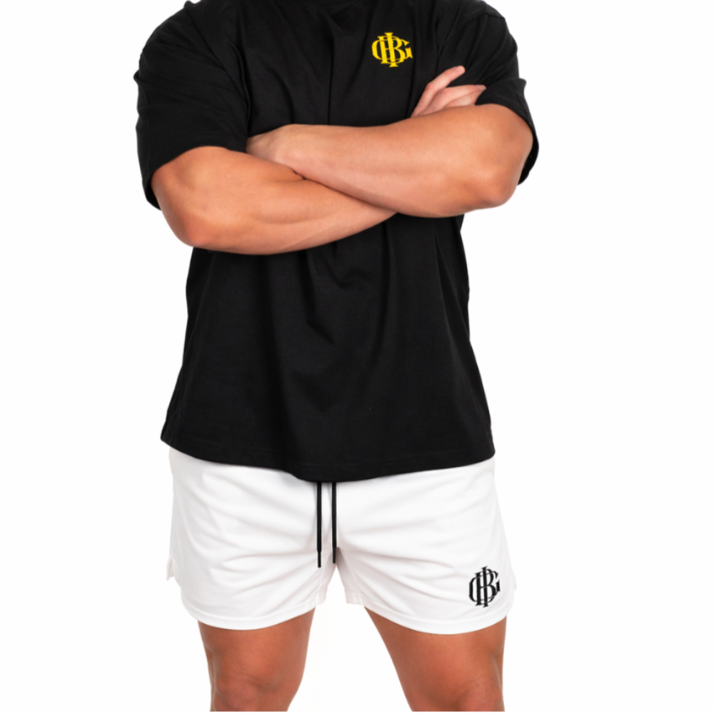 Man wearing the white BIG gym shorts, second full length shot